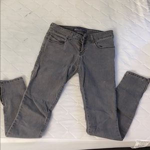 Grey worn skinny jeans with zippers